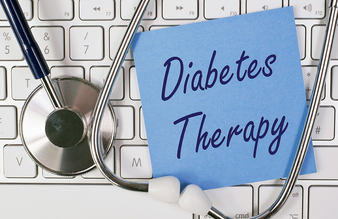 Diabetes therapy written on paper on computer keypad
